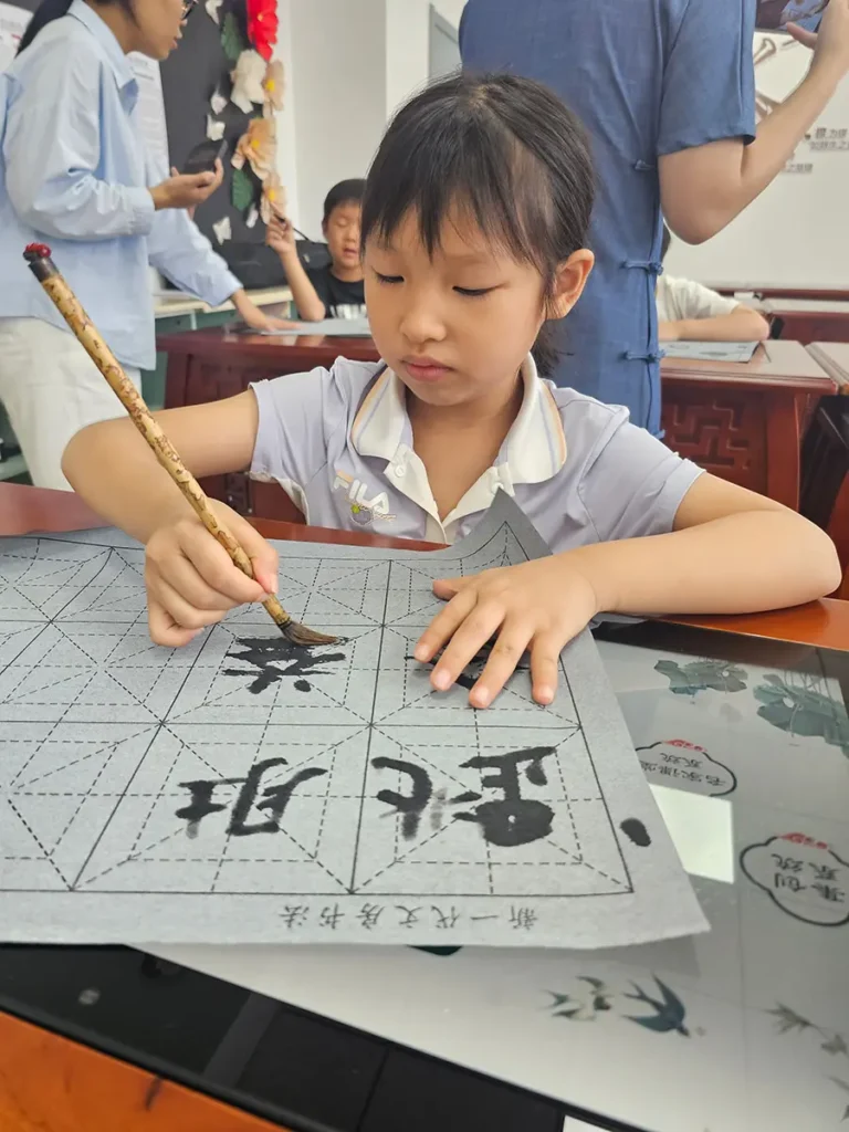 QISS_Students_Practicing_Calligraphy_Tablet_01-768x1024 Students Explore the Art of Chinese Calligraphy